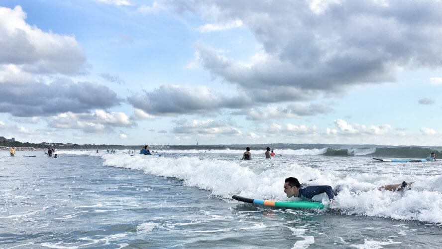 Enjoy surfing in the sea and the fun night in Kuta